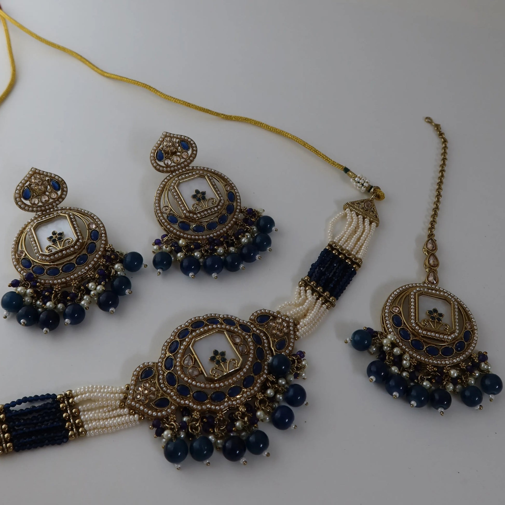 Jewelry set with necklace, earrings, and hair accessories on a white background