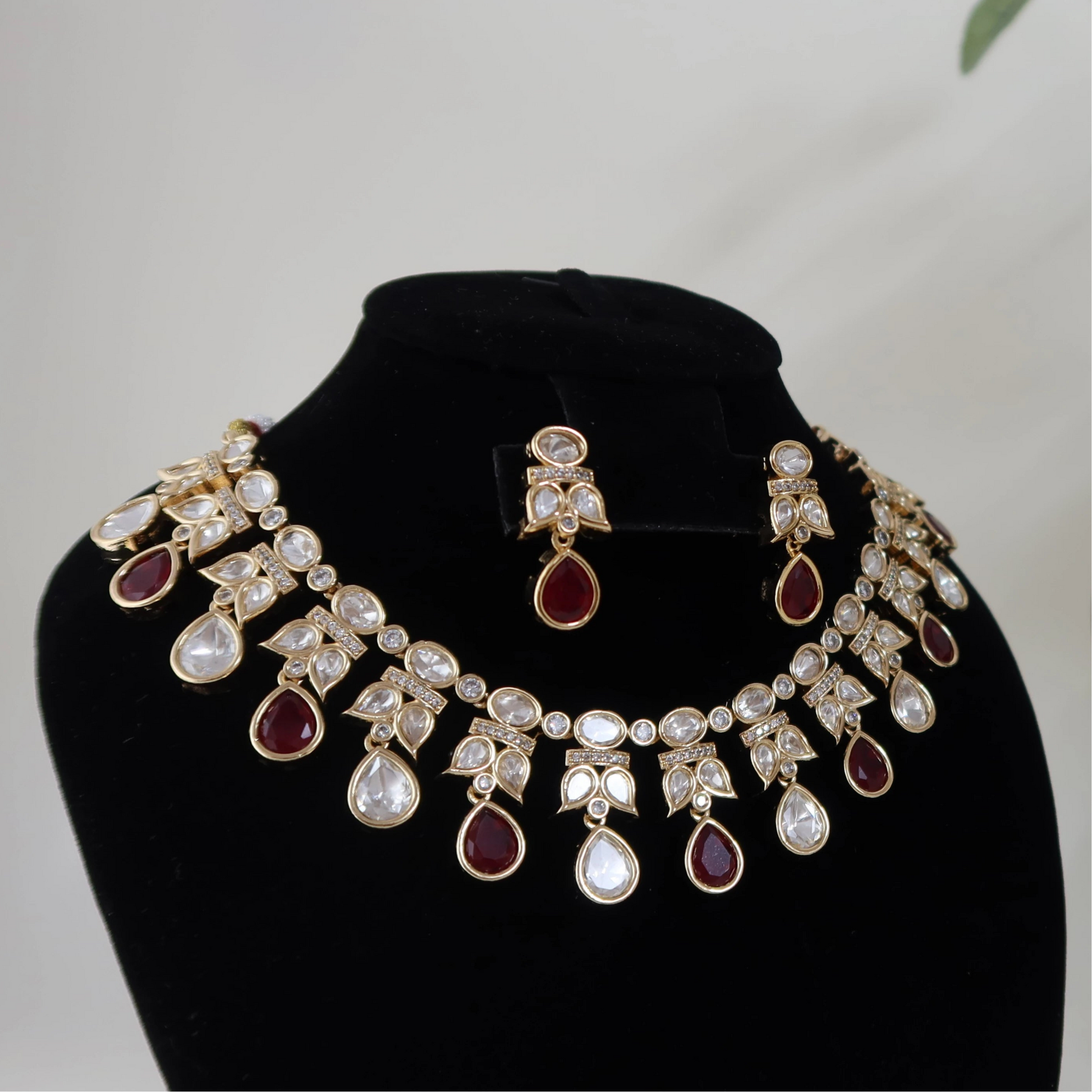 Jewelry set on black stands with a white background