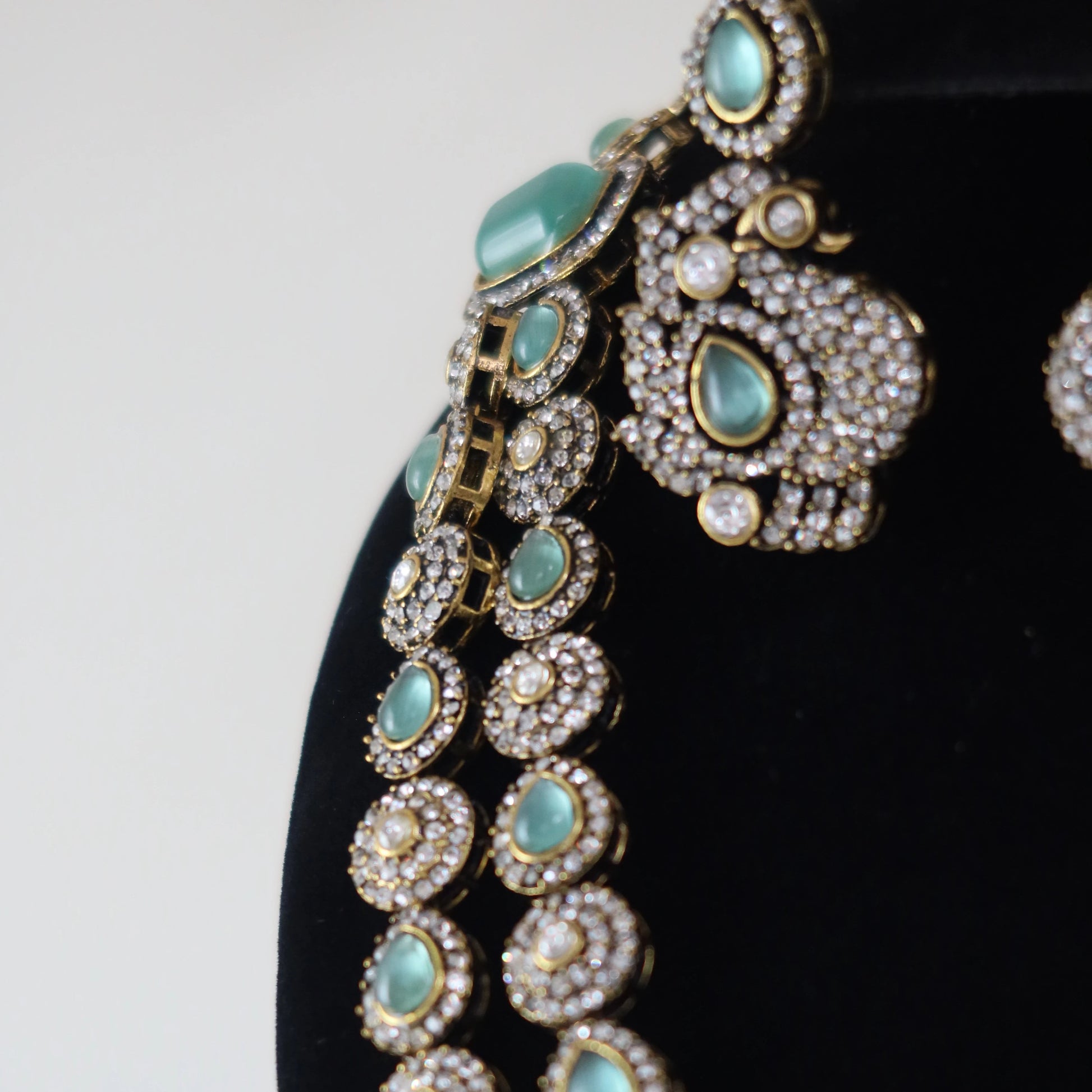 Ornate necklace with turquoise stones on a black background
